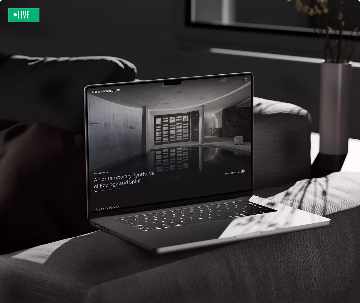 Malik Architecture website on a laptop